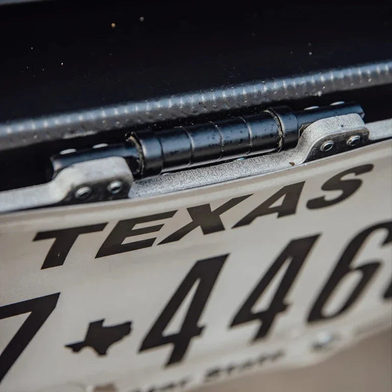 Flip up license plate bracket